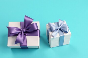 Obraz premium Two elegantly wrapped presents with pastel bows, a delightful visual for celebratory occasions.