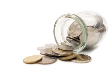 Thai Baht Coins spilled out of jar glass isolated on white background, saving for future, Investment business concept.
