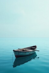 Naklejka premium Serene Solitude A Small Rowboat Gently Bobs on a Calm, Teal Sea, Reflecting the Tranquil Sky Above