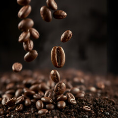Fototapeta premium Roasted coffee beans falling onto ground coffee.