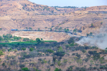 Passenger train hauled by a WCAM3 electric locomotive near Pune India.