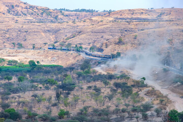 Passenger train hauled by a WCAM3 electric locomotive near Pune India.