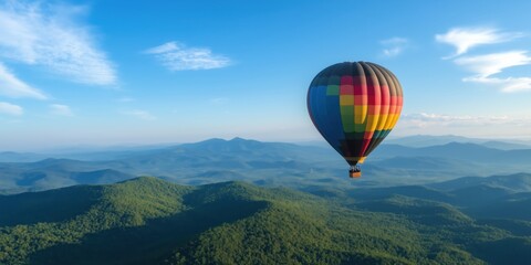 Fototapeta premium A vibrant hot air balloon takes flight over lush green hills, capturing the beauty of nature and the thrill of adventure that comes with ballooning experiences.