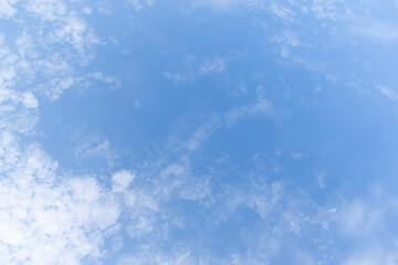 beautiful blue sky and white fluffy group of clouds with sunrise in the morning, natural background