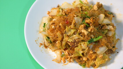 stir fried sukiyaki with egg and pork on white plate