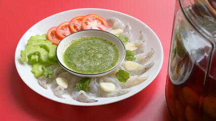 shrimp in fish sauce with Thai spicy seafood dipping sauce on white plate and umeshu