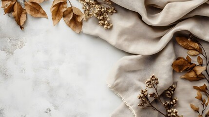 Fototapeta premium Brown leaves and linen fabric on textured neutral surface
