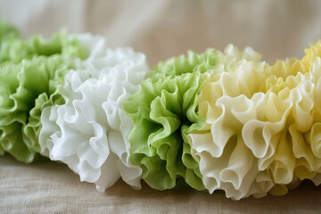 Close-up of a white chrysanthemum flower with soft petals, surrounded by romantic floral decorations in yellow and pink tones, perfect for a wedding or nature-inspired theme