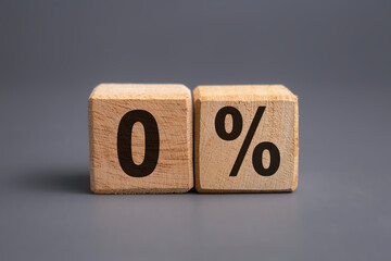 zero percent letter symbol on wooden blocks isolated on grey background. business financial concept