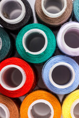 sewing reels with multicolored threads. taken as a background or desktop wallpaper, close-up