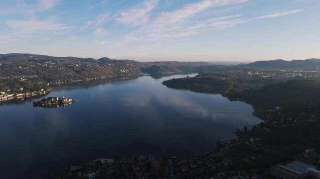 Capturing an aerial view of Lake Orta, featuring San Giulio Island with the majestic Alps rising in the background, creates a serene landscape