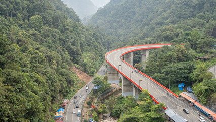 Kelok 9, an iconic winding bridge in West Sumatra, Indonesia, surrounded by lush tropical forest...