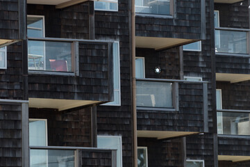 Condo building numerous balconies on the wall covered by cedar planks
