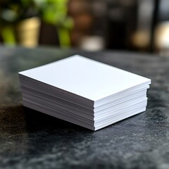 Stacked Blank White Paper Sheets on Dark Surface