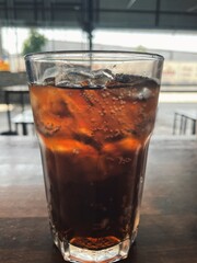 Cola soft drink and ice cubes