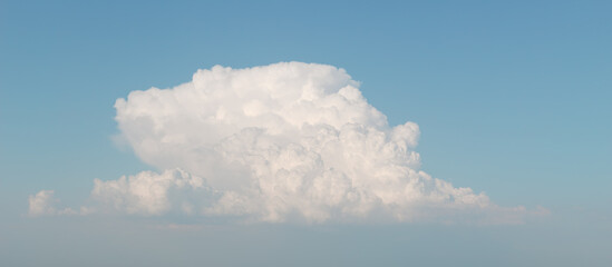 Large cumulus cloud in clear blue sky