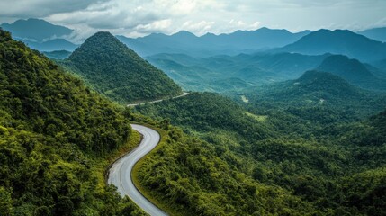 Serpentine mountain road through dense greenery,