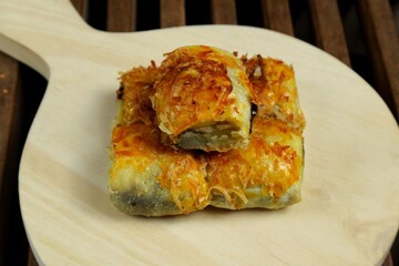 Banana Bolen Wrapped in Puff Pastry is a typical Indonesian baked bread cake with baked flour with...