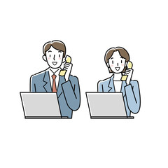 パソコンの前で電話をするスーツの男女