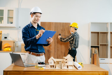 Architects and engineers collaborate on a building model, designing, planning, and measuring with teamwork,