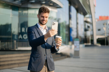 Modern businessman outdoors, using a tablet. Ideal for business, technology, and innovation themes.