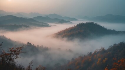 A misty autumn mountain landscape at dawn, showcasing the blurred outlines of distant hills. The scene captures the serene fall ambiance in the remote northern foothills of China, shrouded in fog a...