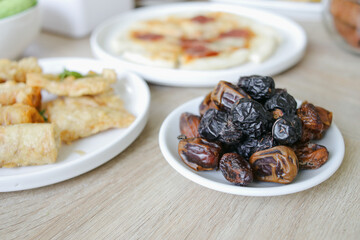 Dates Fruit in a Plate With Other Side Dishes Served on The Table