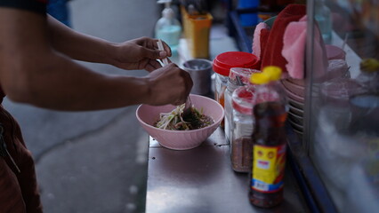 hand holding a basket of fruit