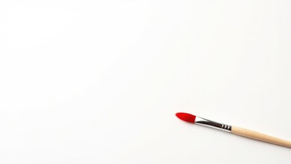 solitary red paintbrush against a white background