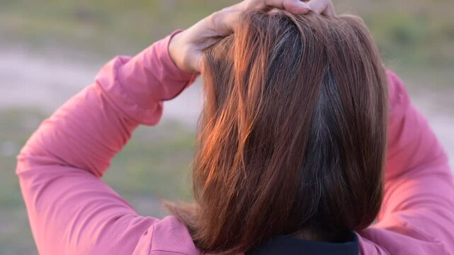 Asian woman's gray hair, Grey color hair of Asian, Regrown gray roots of dyed hair on head of woman, Dry and damaged hair