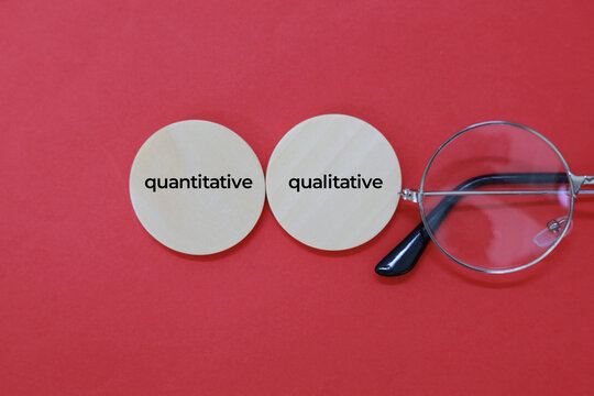 magnifying glass and paper with the words quantitative and qualitative