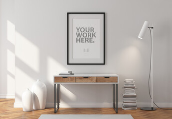 Vertical poster with black frame mockup hanging on wall in room