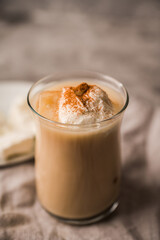 Coffee with ice cream and cinnamon in glass cup. Selective focus.