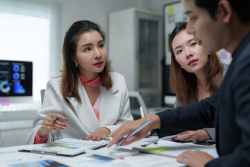 Business people analyzing charts and reports in a meeting room