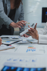 Businesswomen calculating tax using calculator in office meeting
