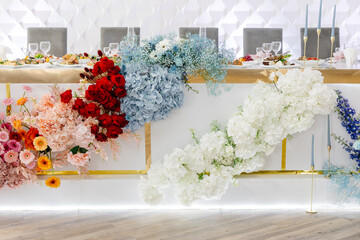 Wedding table decorated with colorful flowers and candles