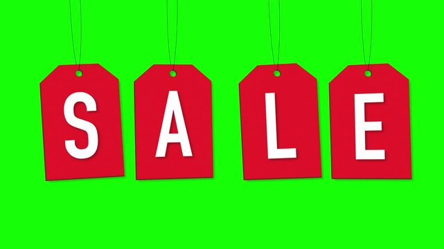 Hanging red SALE tags on green screen.