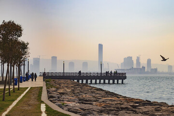 Obraz premium Izmir, Turkey - March 1, 2025: Bayrakly embankment with a view of skyscrapers