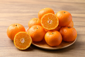 Mandarin tangerine orange fruit on wooden background