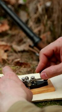 Russian Soviet Infantry Red Army Soldier In World War II using Russian Soviet Portable Radio Transceiver In Trench Entrenchment In Spring Autumn Forest. . Headphones And Telegraph Key. Close Up Hands