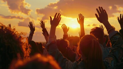 Silhouetted hands raised against a dramatic sunset sky. Hope and unity concept for design and print. Silhouette of diverse people hand putting hand up with sunset. Encouraging, positive. AIG53.