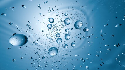 mesmerizing display of bubbles and water droplets floating through a vibrant blue setting, creating...