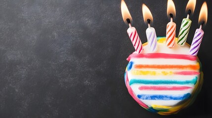 Obraz premium Rainbow Birthday Cake with Lit Candles Festive Treat