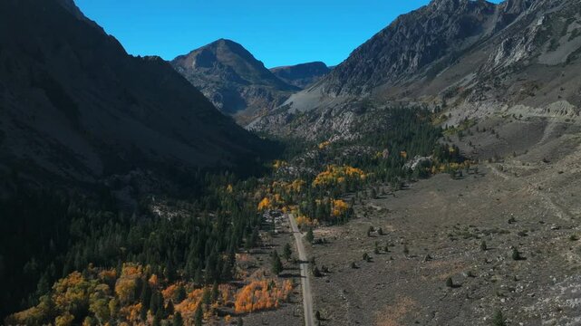 West Portal Entrance Mountains Lee Vining Tioga Pass Road Yosemite National Park California aerial drone Ansel Adams Wilderness Big Oak Flat fall autumn yellow orange Aspen Trees blue skies forward