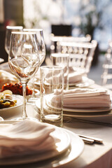 Table setting at a modern dining venue during sunset with elegant decor