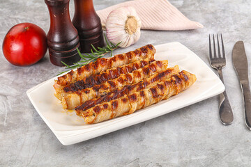 Grilled meat sausages wrapped bacon