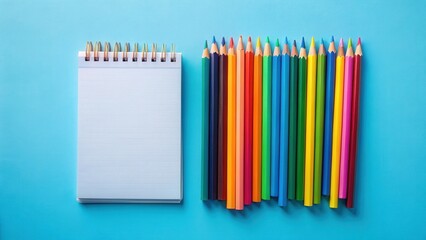 Blank Spiral Notebook and Colorful Pencils on Blue Surface Ready for Creative Ideas