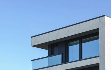 Modern architectural design of a building balcony against a clear blue sky