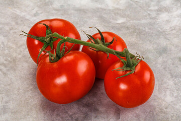 Ripe fresh tomato on the branch