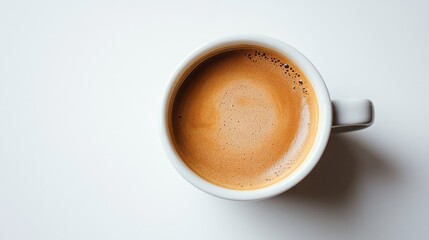 Fototapeta premium A delightful cup of coffee sits on a pure white background, radiating warmth and inviting comfort with its rich aroma. Perfect for starting the day or enjoying a cozy afternoon break